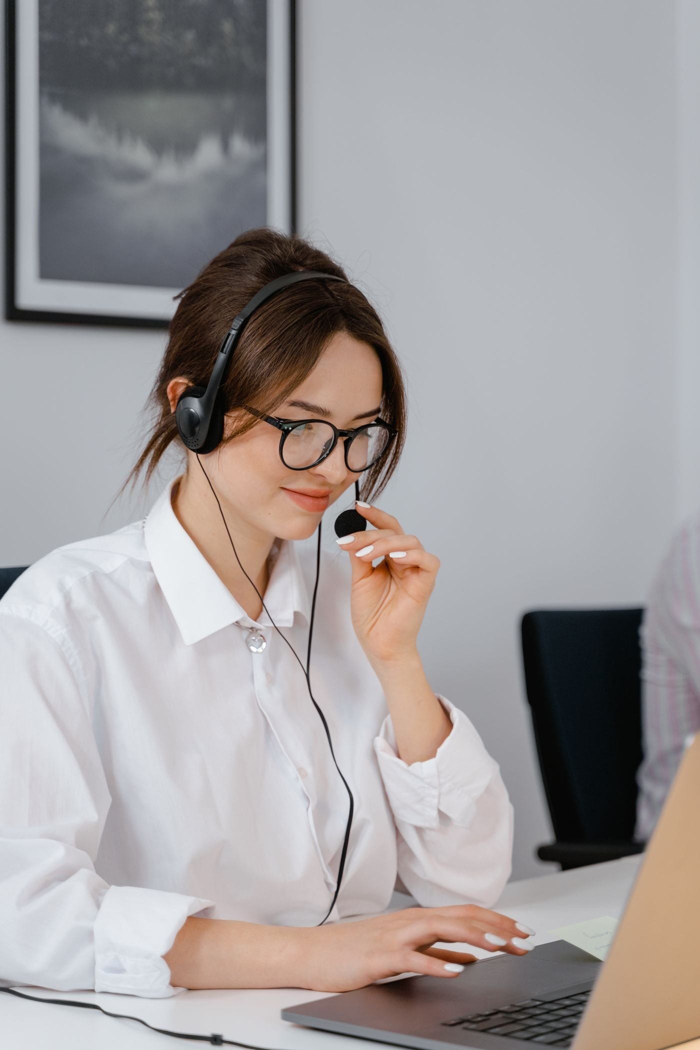 Customer support professional wearing a headset in a bright office